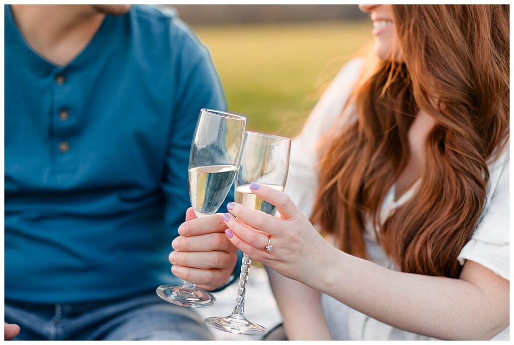 Engaged couple sharing champagne at sunset for photos at Greenhill Park in Roanoke, Virginia 