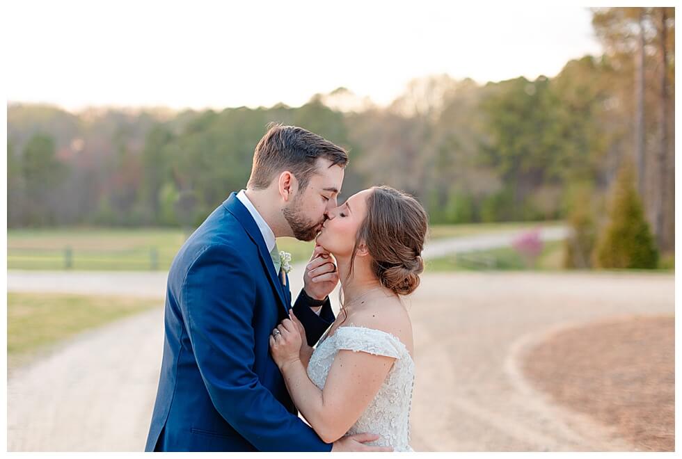 Couple sharing a kiss for photos at The Pavilion At Carriage Farm