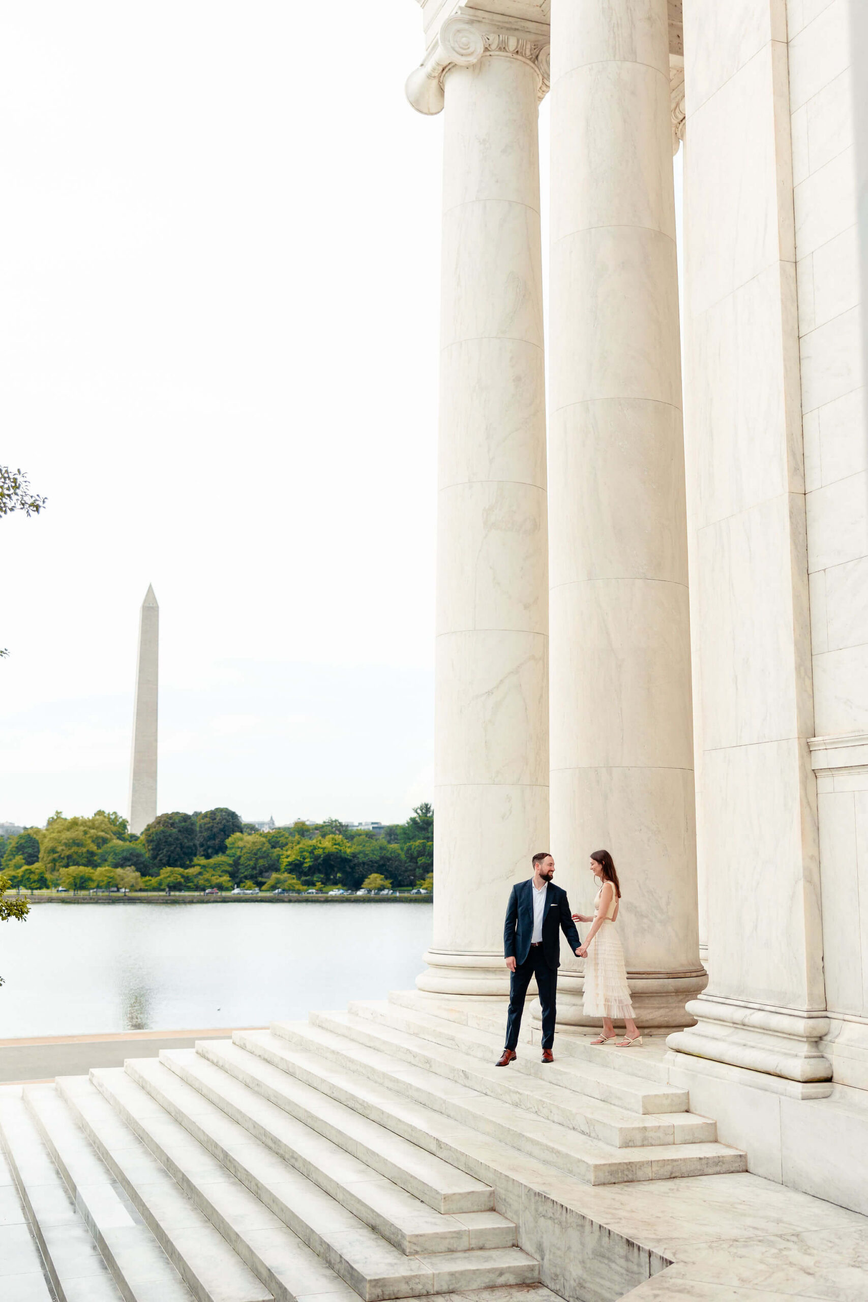 A man and his fiancee walk down the steps while laughing at one of the Engagement Session Locations in Northern Virginia