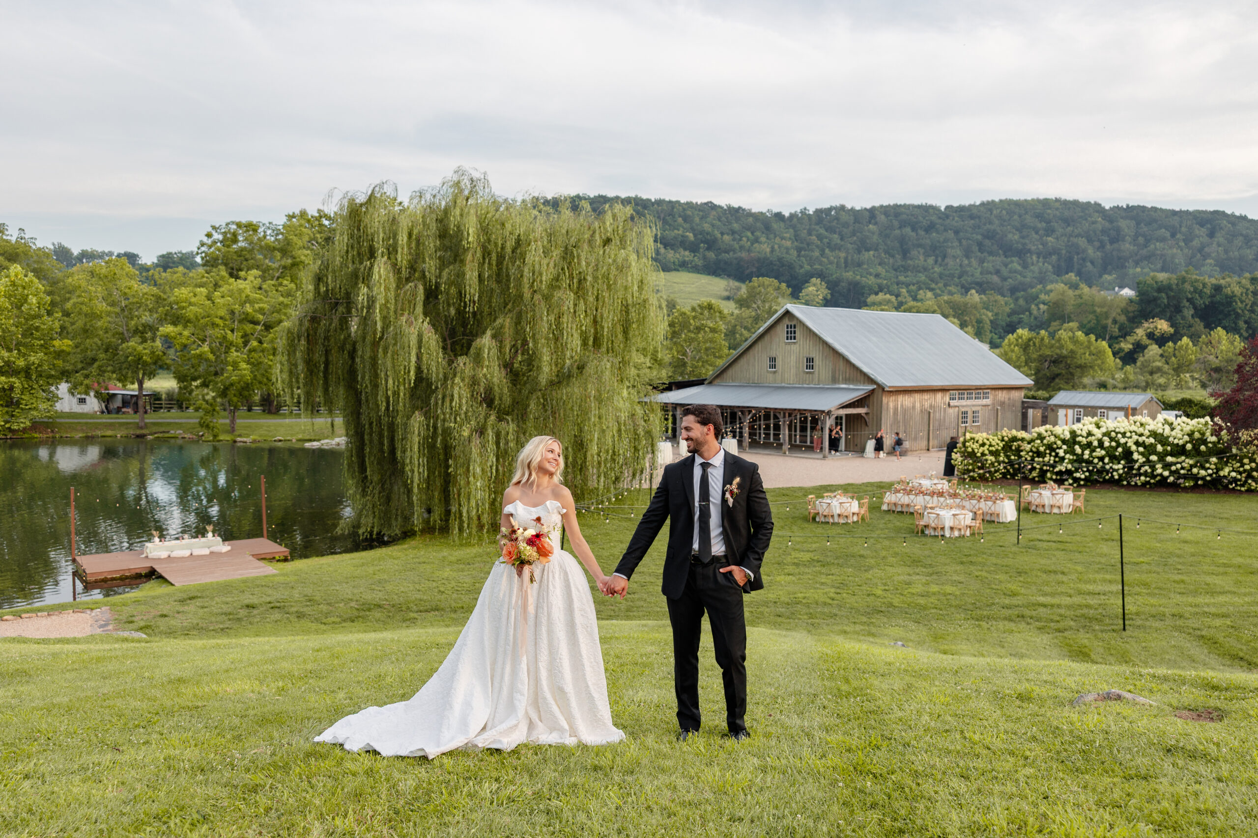 Couple Looking at each other on the hill at Big Spring Farm Wedding Venue