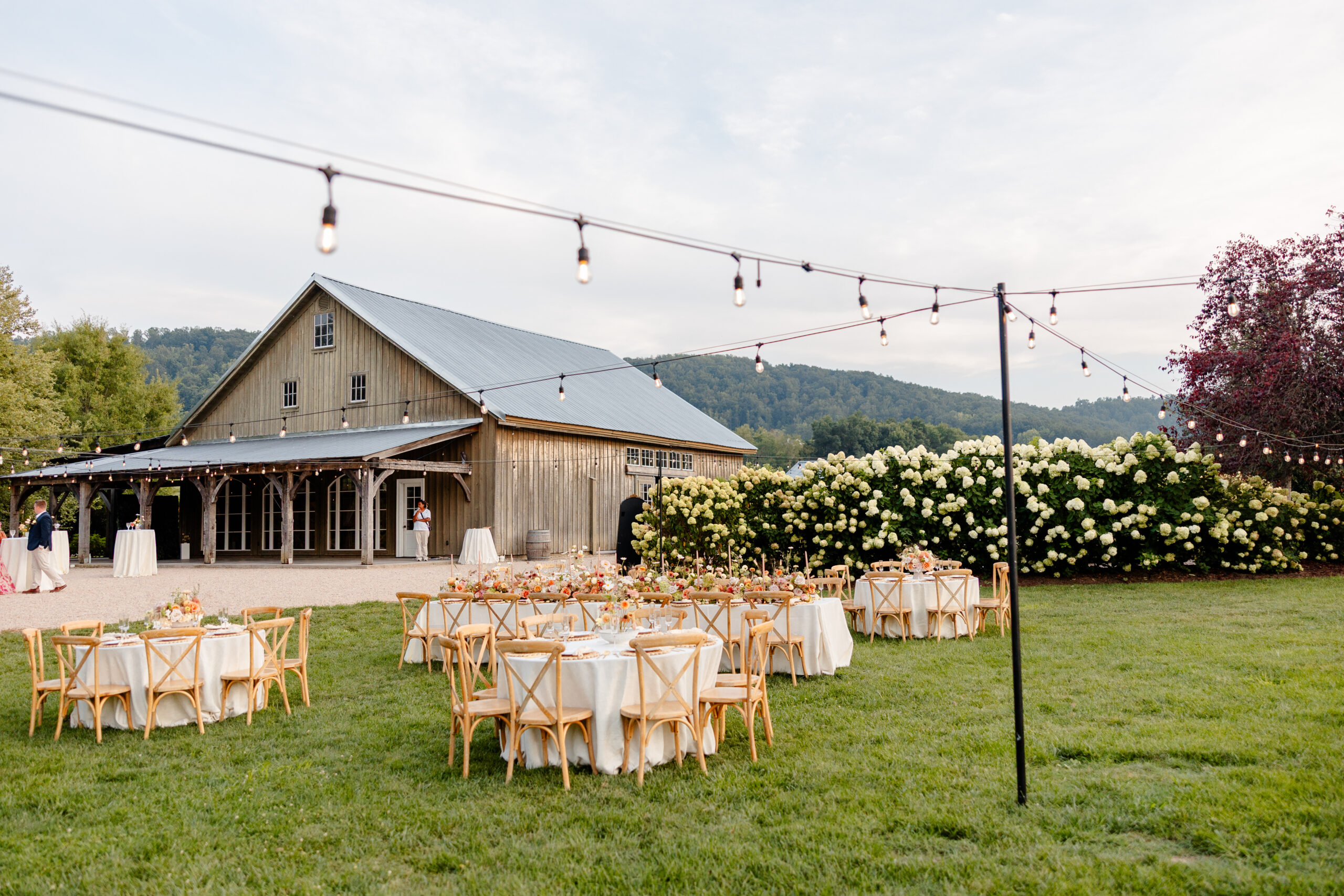 Gorgeous outdoor reception set up at Big Spring Farm with summer florals